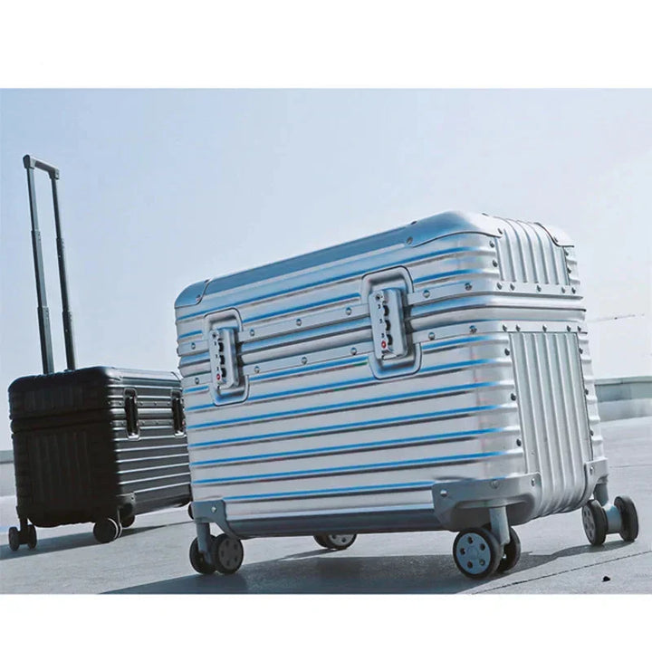 Integrated TSA lock on a silver aluminum-magnesium hardshell suitcase, securing valuables for travel.