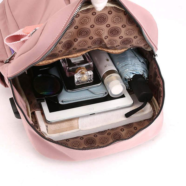 Close-up of the integrated USB charging port on the anti-theft travel backpack for convenient power.