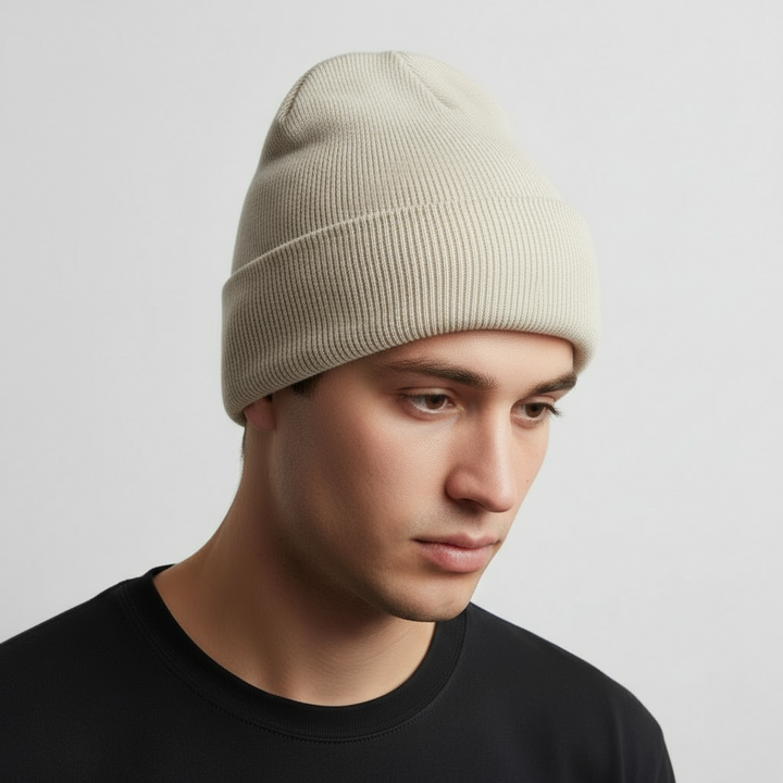 Model wearing a red knitted acrylic beanie hat, 'FrostKnit' embroidered, looking warm & stylish.