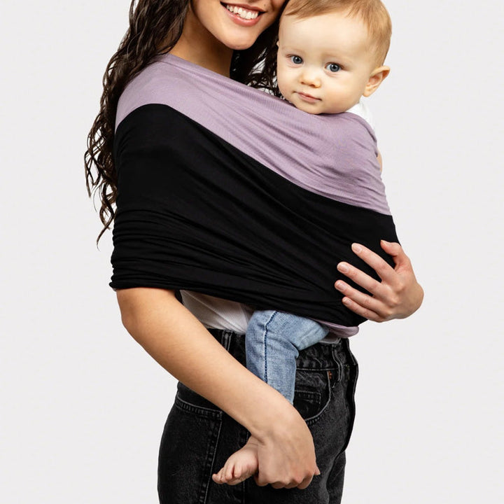 Ergonomic baby wrap carrier offers comfortable, secure support for hands-free newborn carrying.