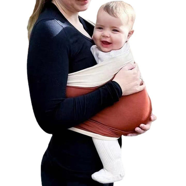 Parent wearing a comfortable baby wrap carrier, enjoying hands-free time with their newborn.