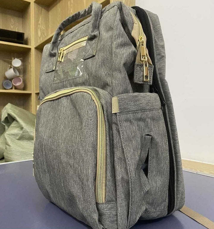 Waterproof parenting essential: nappy bag open to reveal organized compartments and bassinet