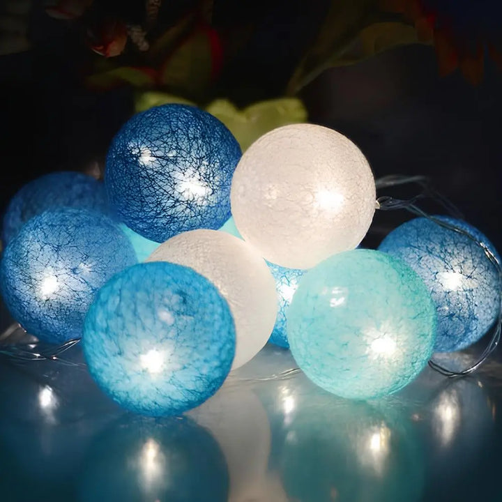 Cotton ball string lights wrapped around a mirror, enhancing reflections with soft ambient light.