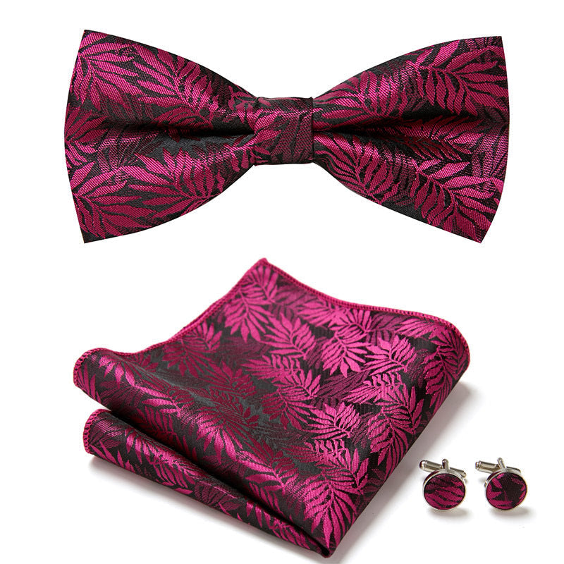 Unisex floral bow tie set with intricate design, includes matching pocket square and cufflinks for formal wear.
