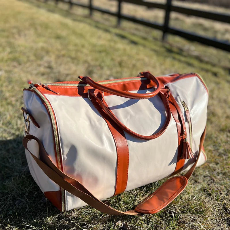 Compact foldable garment bag for easy storage & travel; ideal for suits, dresses, & formal wear.