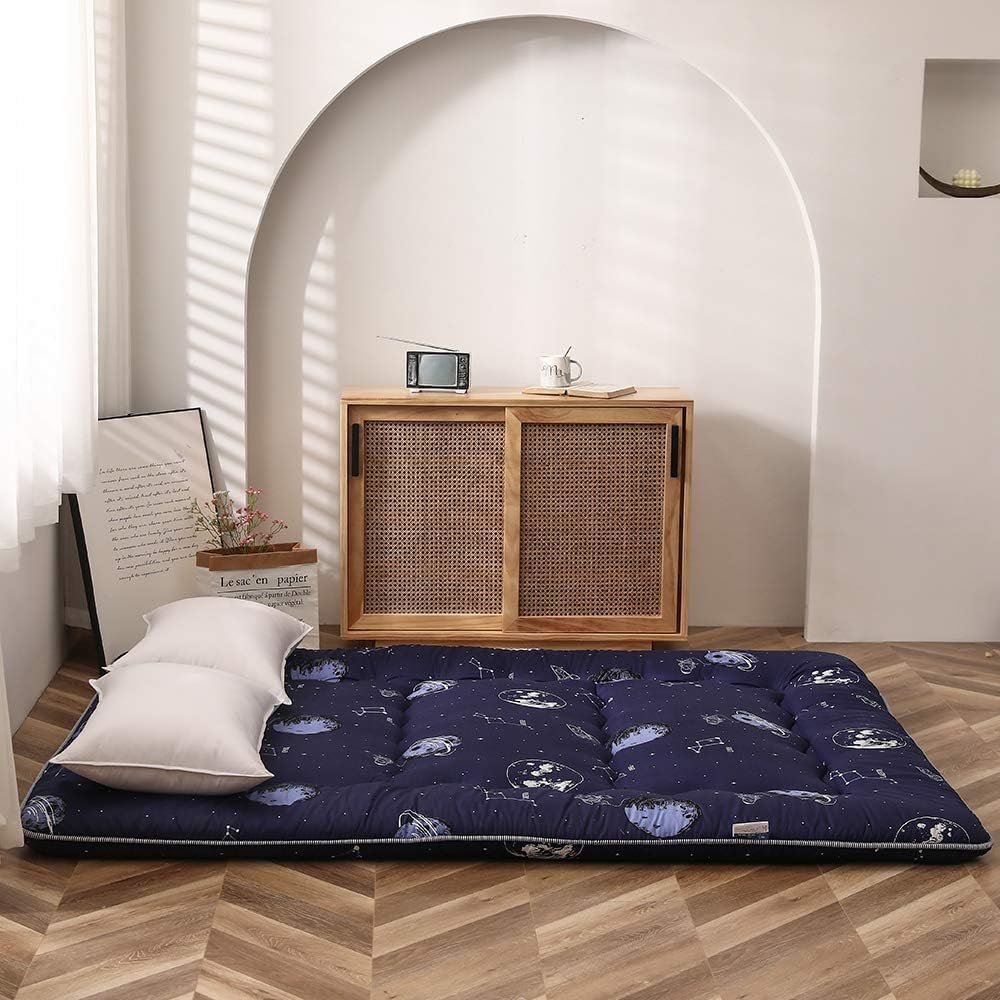 Foldable futon, Japanese design, memory foam, offers a cozy alternative to traditional beds
