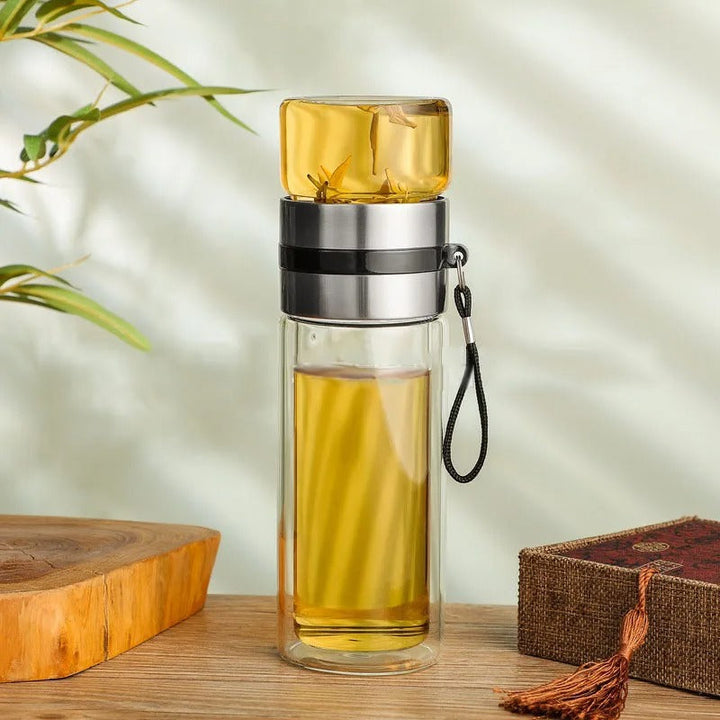 Versatile glass water bottle with tea infuser. Insulated for hot coffee, cold water, or herbal infusions.