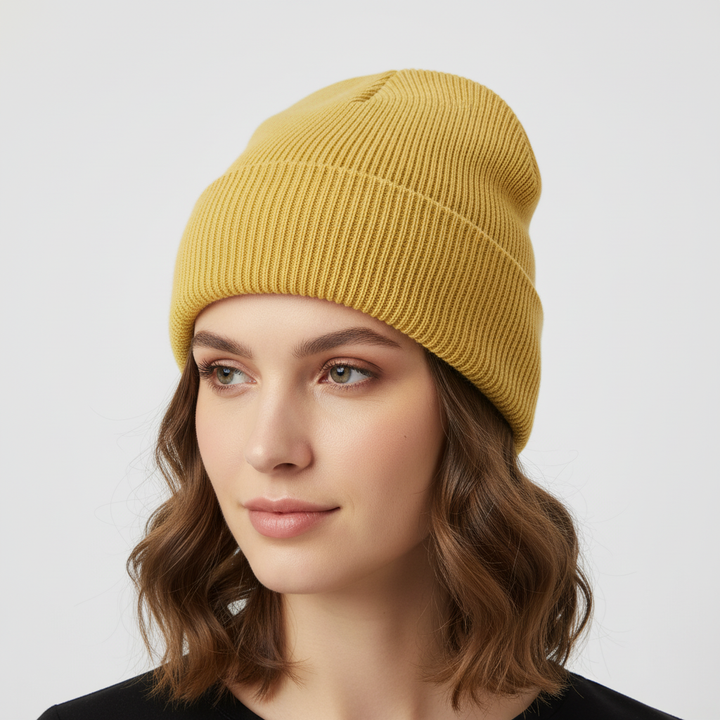 Person adjusting a blue knitted one-size beanie, showcasing its flexible fit