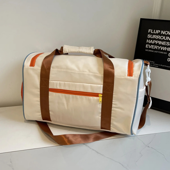 Open view of the spacious lightweight FlexaBag duffle. Blue, green, orange color blocks & durable zippers.