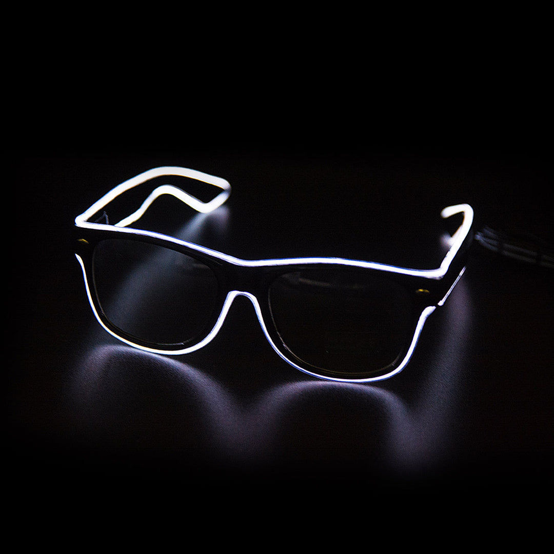 Person wearing LumaGlow LED Light Up Glasses at a festival, blue glow