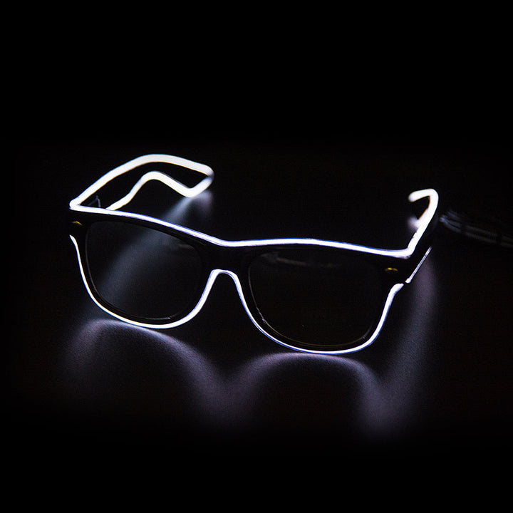 Person wearing LumaGlow LED Light Up Glasses at a festival, blue glow