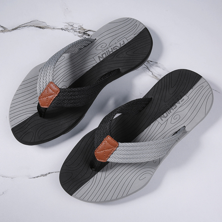 Top-down view of comfortable unisex flip flops, highlighting padded straps & sleek design.