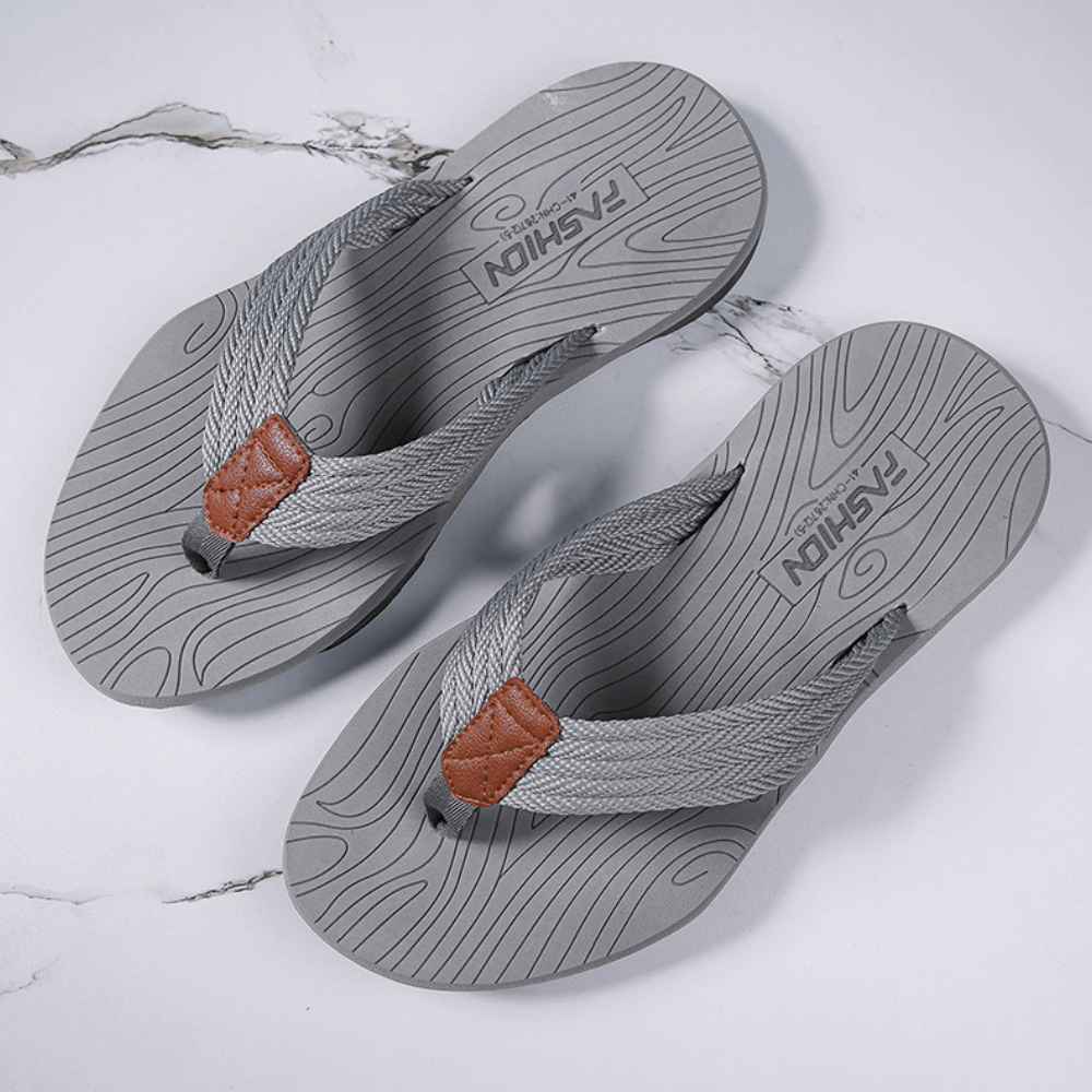 Model wearing orthopedic flip flops, experiencing arch support & comfort for everyday activity.