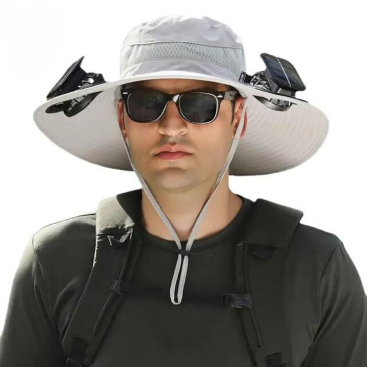 Person wearing a beige CoolBreeze solar fan hat outdoors, providing sun protection and cooling