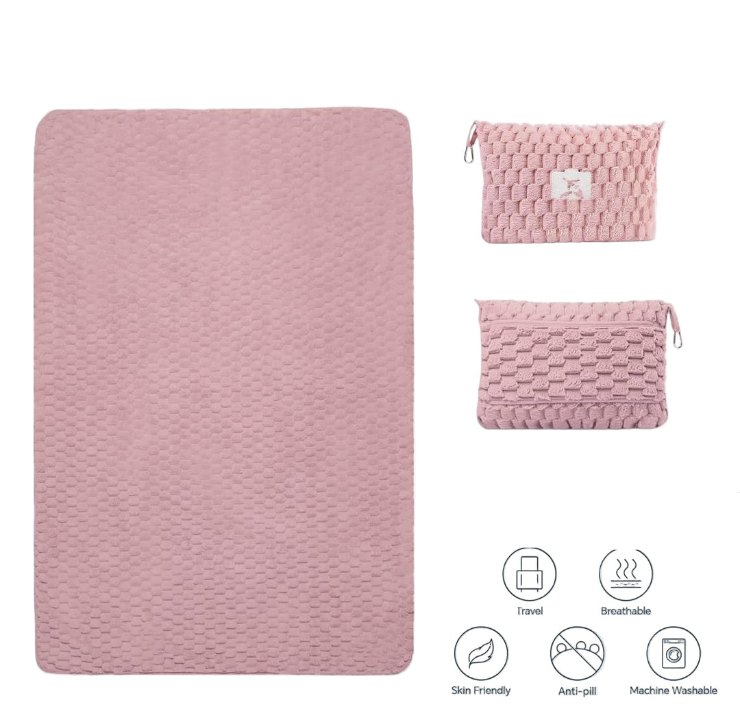 Folded grey flannel travel blanket converting into a compact pillow with zipper closure