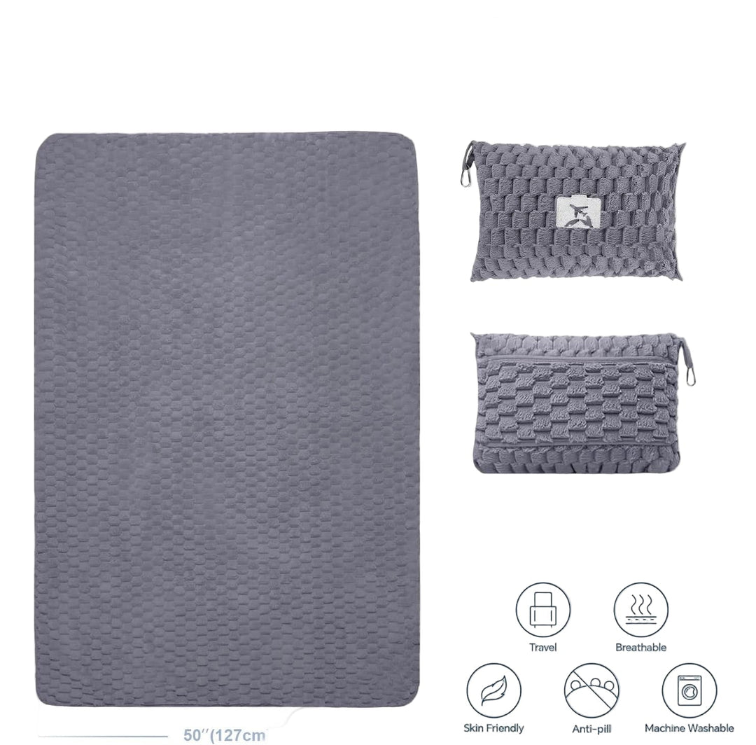 Grey flannel travel blanket with pillow, showcasing its portability and versatile design