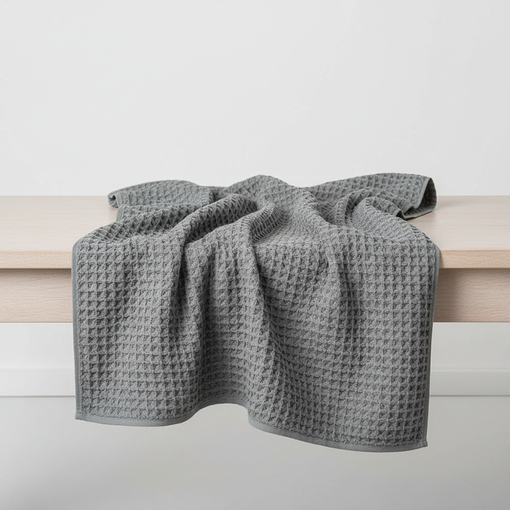 Stack of multiple colored ultra-soft Pima cotton waffle towels, FreshWrap for quick-dry luxury