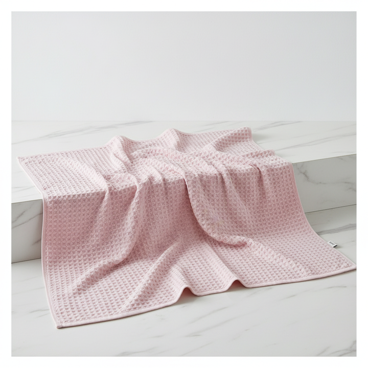Embroidered logo on an ultra-soft FreshWrap Pima cotton waffle towel, highlighting quality and luxury