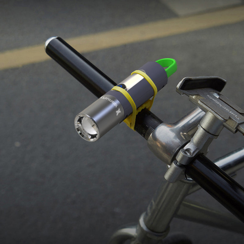 Unisex LED flashlight illuminating a campsite, essential gear for night camping.