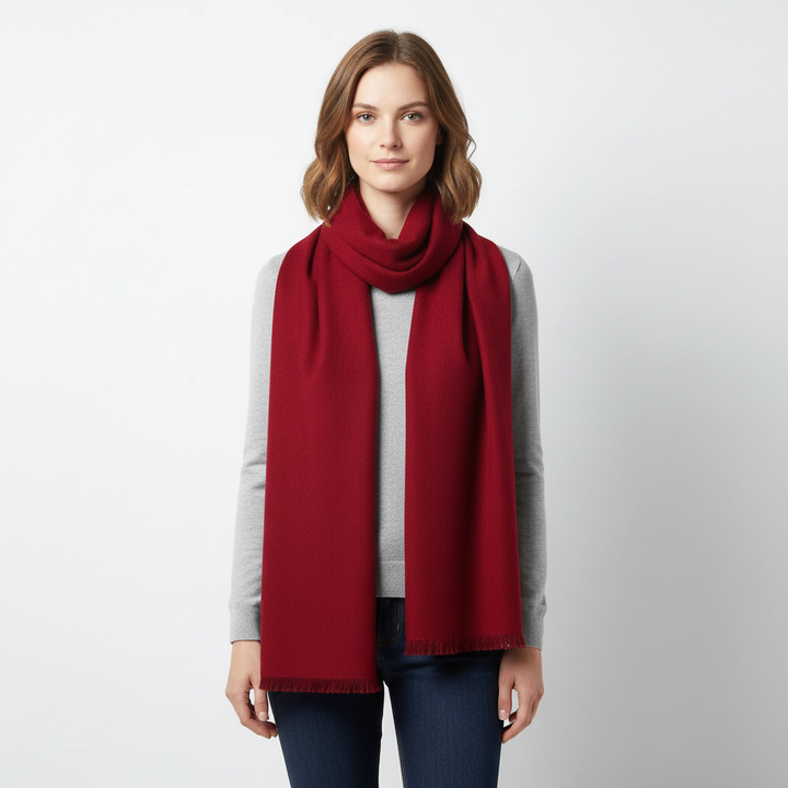 Close-up of the woven texture of a warm cashmere-feel winter scarf, emphasizing its softness.