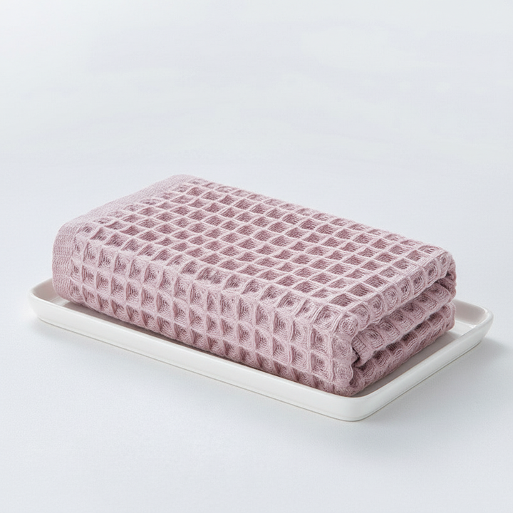Green absorbent unisex waffle towel, perfect for bath or spa, made from natural fabric.
