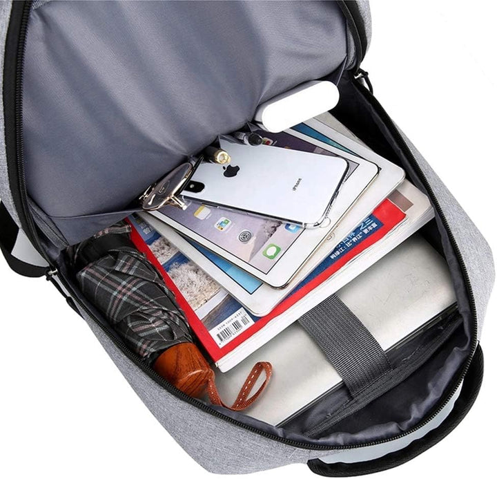 Overhead view of the slim waterproof laptop backpack packed with essentials, highlighting its spacious yet compact design