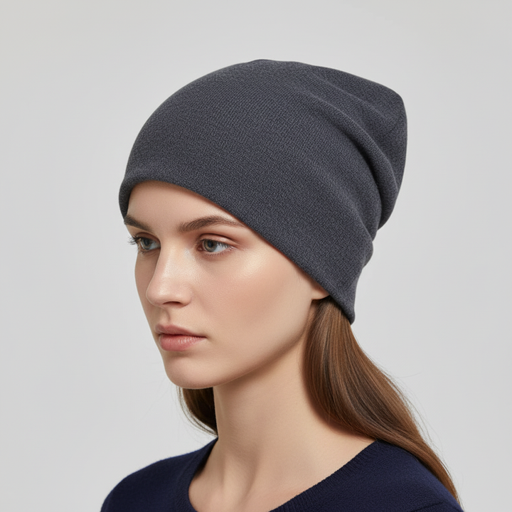 Textured slouchy wool beanie in a classic cream color, providing warmth and comfort for all genders