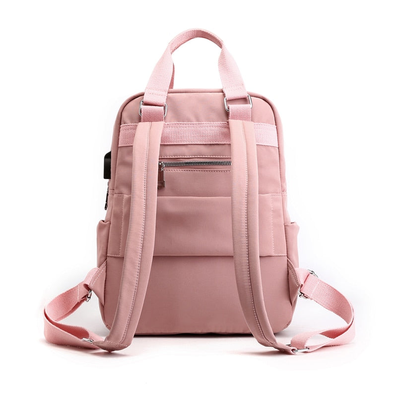 Person wearing a water-resistant anti-theft backpack in an urban setting