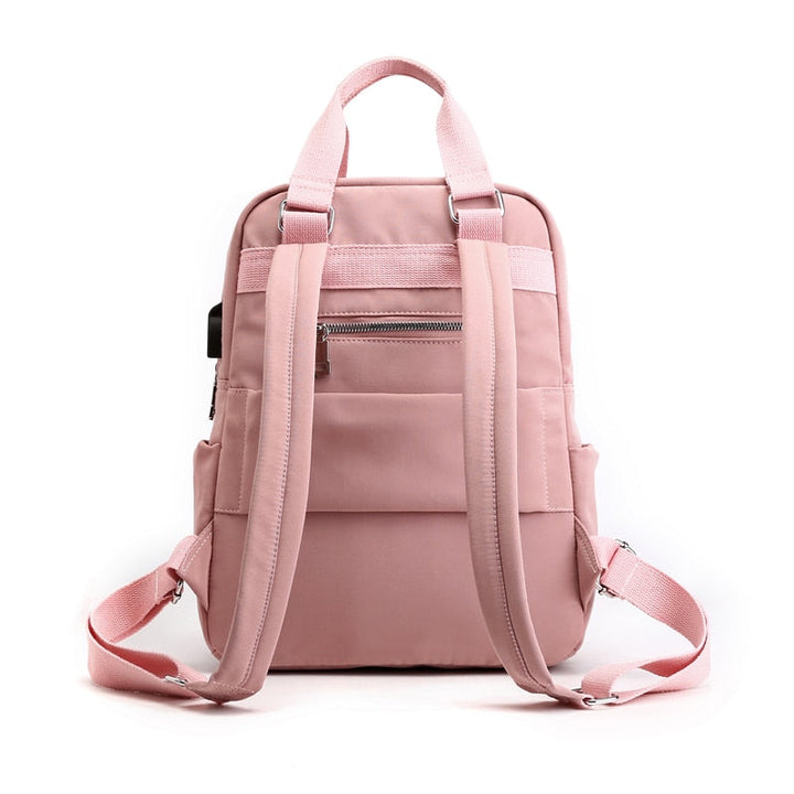 Person wearing a water-resistant anti-theft backpack in an urban setting