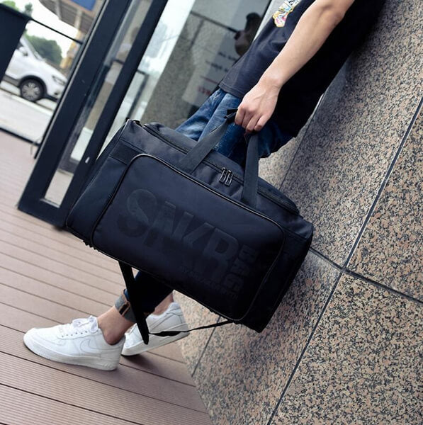 Front view of the water-resistant travel bag, highlighting secure zipper compartments.