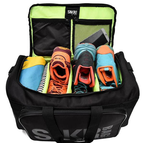 Gear travel bag, water-resistant, held by a person, illustrating size and portability