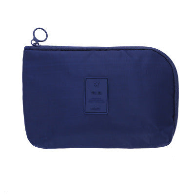 Unisex travel organizer for electronic gadgets, displaying its portable size