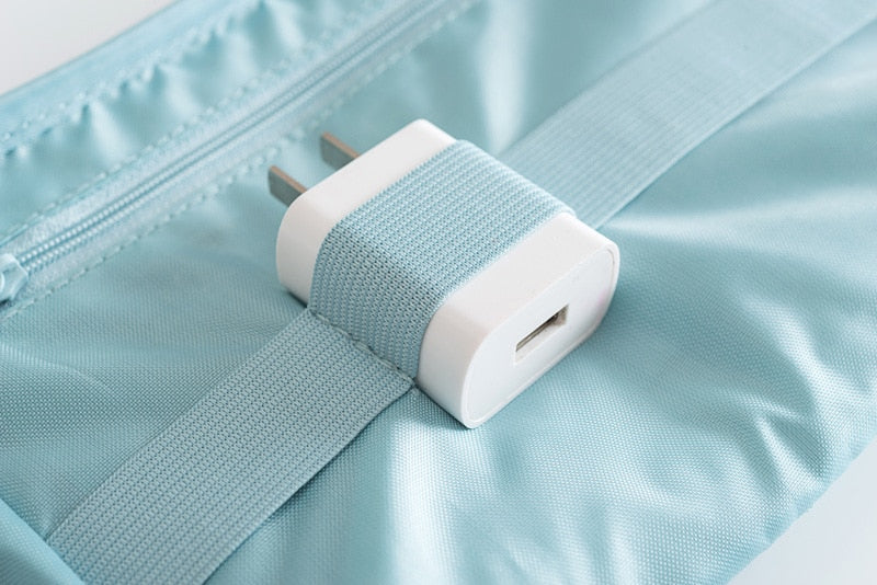 Travel tech organizer, fully packed with various charging cables and adapters