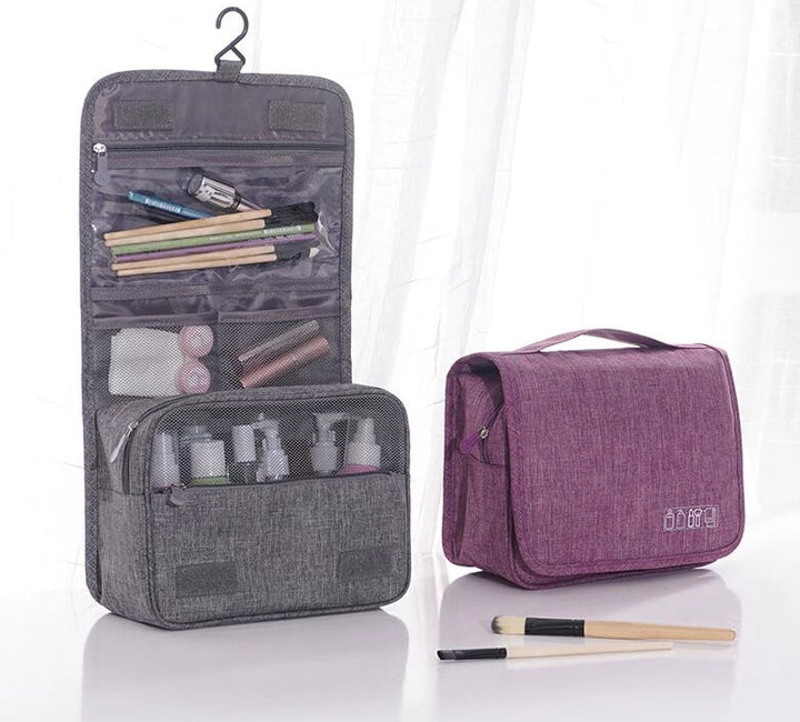 Unisex waterproof hanging toiletry bag organizer in black, opened with multiple compartments.