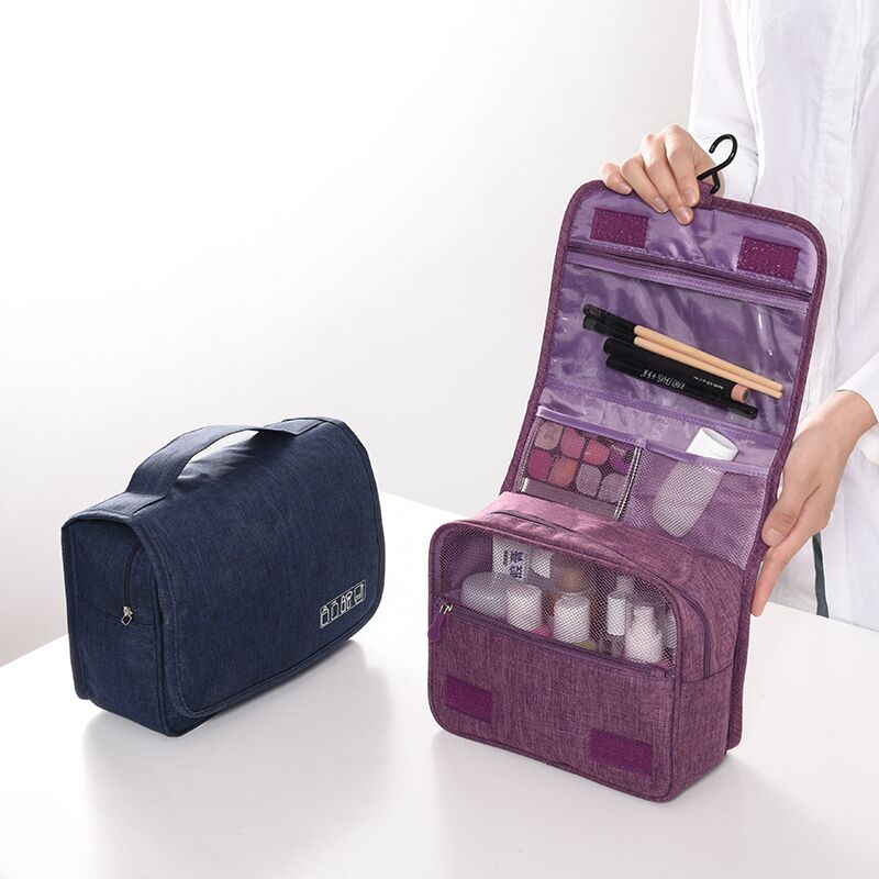 Waterproof unisex cosmetic bag organizer, open and revealing mesh pockets and zippered sections.