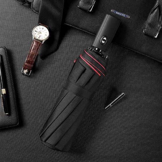 Open AeroShield unisex compact windproof umbrella in black, protecting from heavy rain, travel-ready
