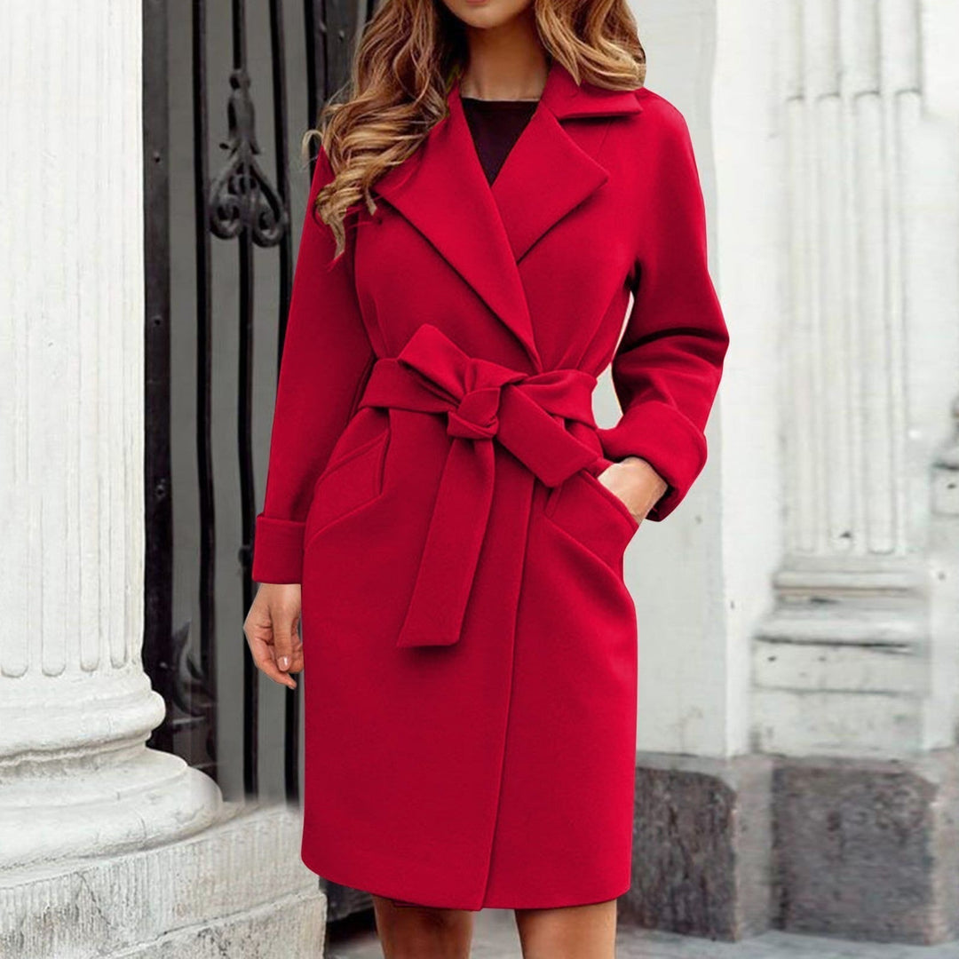 Bright colored long women's trench coat with classic button closure, a trendy and warm outerwear choice.