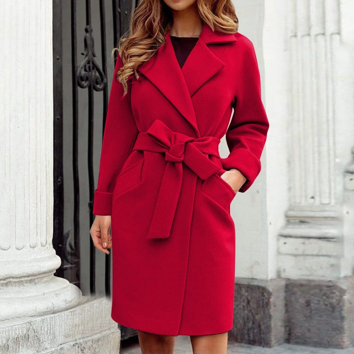 Bright colored long women's trench coat with classic button closure, a trendy and warm outerwear choice.