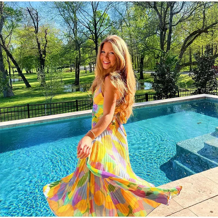 Elegant sleeveless summer dress with a vibrant floral pattern, deep neckline, and charming bow closure.