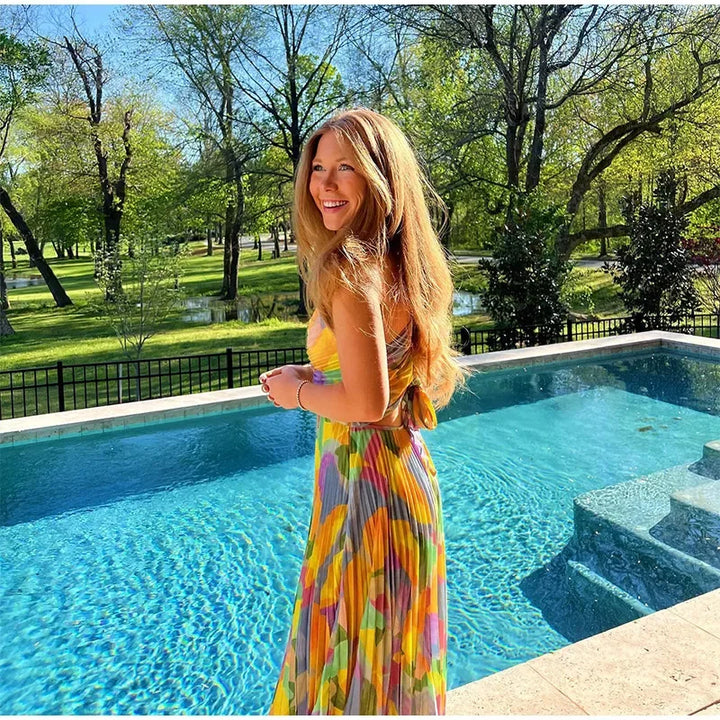 Vivienne women's floral summer dress, midi length, deep V-neck, and chic bow-back for feminine style.