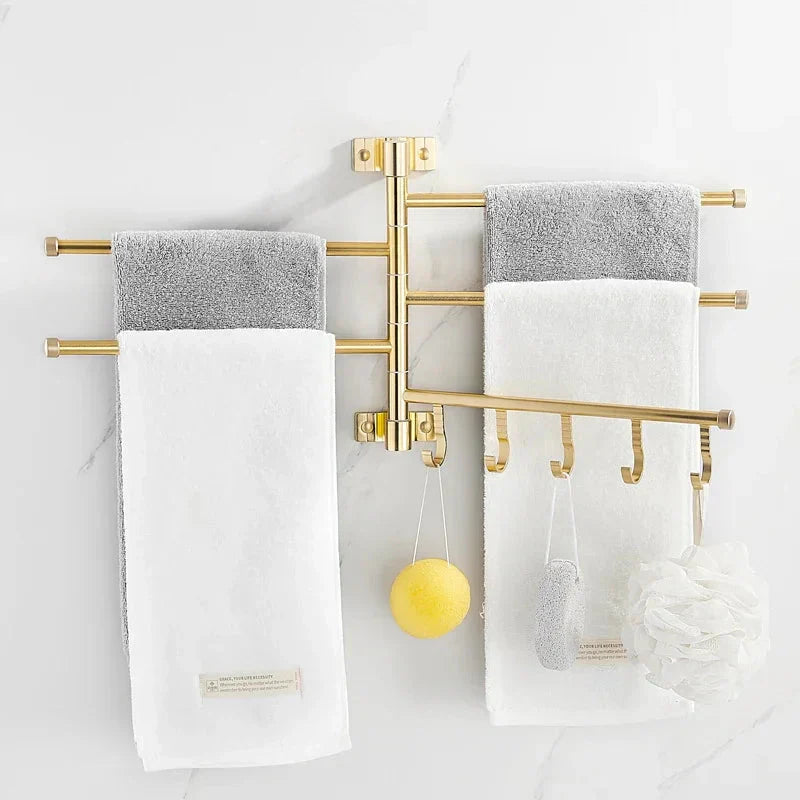 Elegant wall-mounted triple arm towel rack in gold, perfect for organizing towels in any bathroom