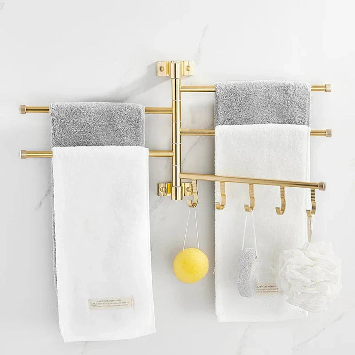 Elegant wall-mounted triple arm towel rack in gold, perfect for organizing towels in any bathroom
