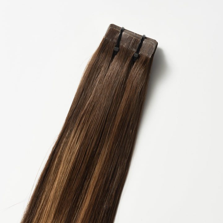 Warm Brown Balayage human hair tape-in extensions for women, adding natural volume & length.