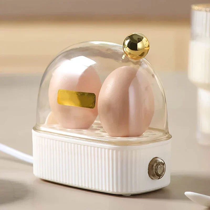Compact electric egg cooker & food steamer in white, perfect for quick, healthy breakfast prep.