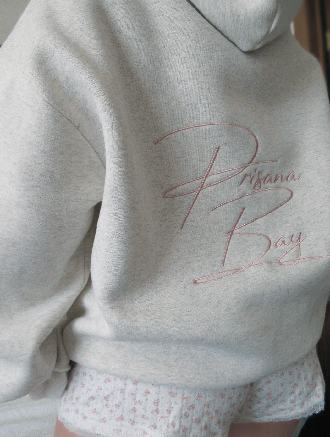 Chic white women's Elodie hoodie with a contrasting pink bow. Elevates your casual feminine style.