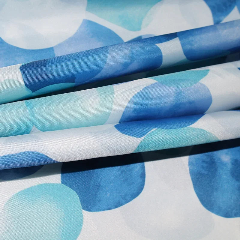 Close-up of SplashDot pattern on water repellent fabric shower curtain with hook detail