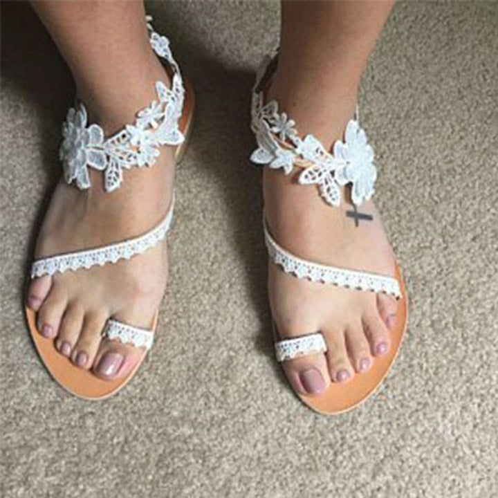Stylish white floral slip-on women's sandals, open toe design for summer beach wear & comfort.
