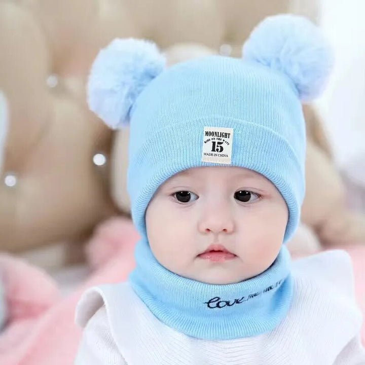 Winter children's knitted beanie with fluffy white pom-pom, perfect for cold weather
