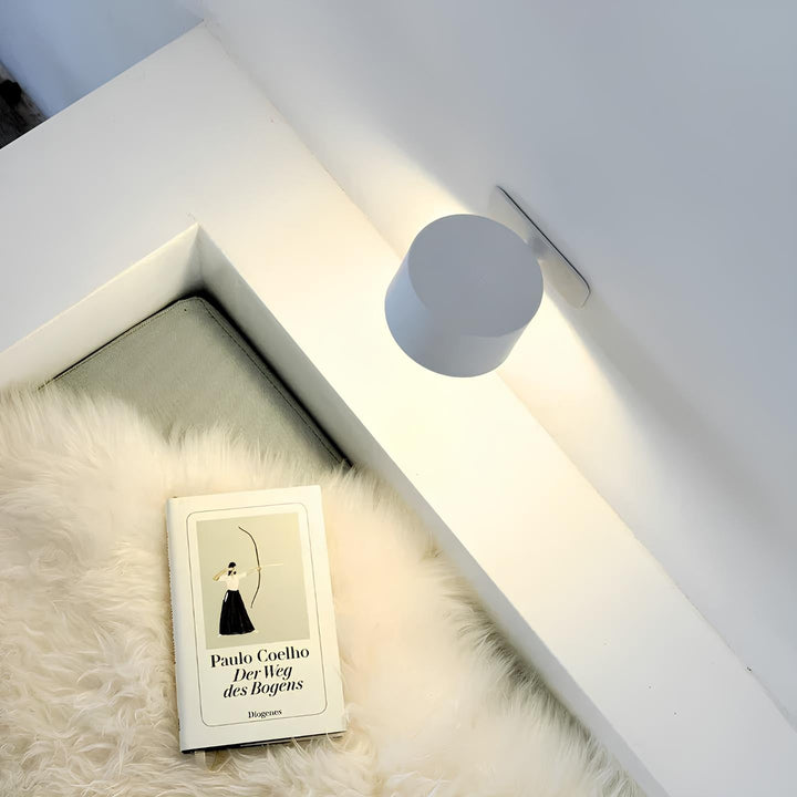 Modern LED wall lamp, black finish, providing warm dimmable light for cozy atmospheres