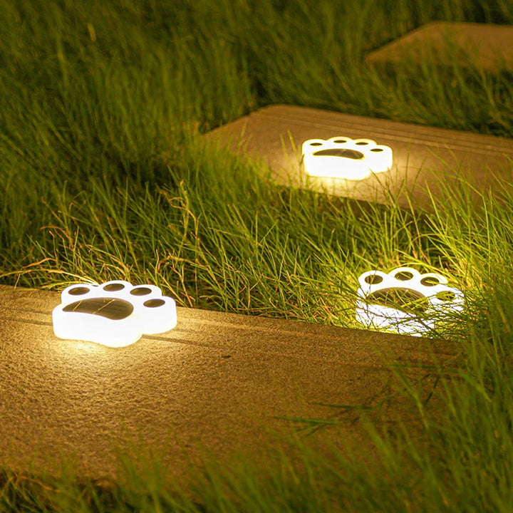 Automatic wireless solar paw print lights add a whimsical touch to outdoor gardens with multi-colored LED pathway decor.